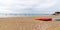 Colorful orange kayaks on ÃŽle de Noirmoutier sandy beach ready for paddlers in sunny day in web banner header template