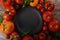 Colorful organic tomatoes - blue tomatoes around an empty clay plate. Tomatoes background