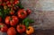 Colorful organic tomatoes - red tomatoes and  yellow tomatoes and basil vith dill. Tomatoes background.