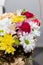 Colorful ornamental variety of flowers in the gift wood basket with roses , leaf and chrysanthemum, daisies,selective