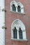 Colorful ornate windows on brick wall