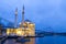 Colorful Ortakoy mosque and Bosphorus Bridge reflection on the sea