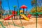 Colorful outdoor modern children playground without children in the play yard view from football net