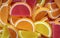 Colorful oval citrus jelly candies pattern background. Yellow, pink, red, orange round shaped marmalade backdrop