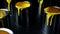 Colorful paint leaking down on wall of metal bucket. Isolated over black background. shot on slider