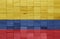 colorful painted big national flag of colombia on a wooden cubes texture