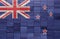 colorful painted big national flag of new zealand on a wooden cubes texture
