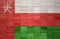 colorful painted big national flag of oman on a wooden cubes texture