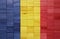colorful painted big national flag of romania on a wooden cubes texture