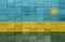 colorful painted big national flag of rwanda on a wooden cubes texture