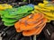 Colorful pair of slippers and shoes displayed for sale.