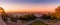 A colorful, panoramic cityscape overlooking Paris at sunrise