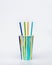 Colorful paper cup or container for coffee or cocktail and paper drinking straws. Bright summer package for beverage.