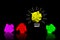 Colorful paperballs light bulbs on black background - idea, creativity concept
