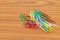 Colorful paperclips scattered on wooden floor background