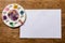 Colorful paperclips scattered on wooden table. View from above.