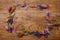 Colorful paperclips scattered on wooden table. View from above.