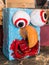 Colorful papier-mache sculpture face with orange beak