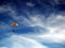 Colorful parachute against blue sky & white clouds