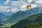 Colorful paraglider wings fly in the mountains near Tolmin, Slovenia