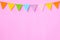 Colorful party flags hanging on pink background, birthday, anniversary, celebrate event, festival greeting card background