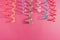 Colorful party ribbon streamers on pink bright background. Party