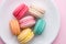 Colorful pastel cake macaron or macaroon on plate.