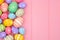 Colorful pastel Easter Egg side border against a pink wood background