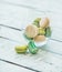 Colorful pastel French macaron biscuits in glass, wooden table background