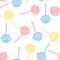 Colorful pastel lollipops on white background in flat style. Seamless background with cute candy.