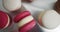 Colorful Pastel Macarons on White Background White Pink and Brown Macaron. Close up of colorful white, red, and caramel