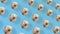 Colorful pattern of chocolate donuts isolated on blue background with shadows. Seamless pattern with donut. Doughnuts