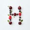 Colorful pattern of letter H english alphabet from natural ripe berries - black currant, cherries, raspberry, mint leaf