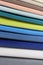 Colorful patterns of upholstery fabric. Close-up of samples of furniture fabric. Multicolored soft velour. Furniture industry. Bac
