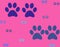 Colorful paws of dog painted on a bright background. Dog paw print seamless pattern on background.