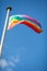 Colorful peace flag in blue sky