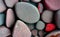 Colorful pebble stone background texture with red and black spots