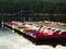 Colorful pedal boat row at jetty in the sunset light, evening mood