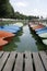 Colorful pedal boats moor at the dock