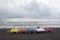 Colorful pedalo pedal boat on the beach, overcast, clouds, waves