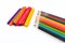 Colorful pencil crayons over a white background