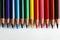 Colorful pencils arranged as a color pallete on paper