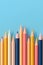 Colorful Pencils Arranged on Blue Background. Generative AI
