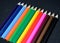 Colorful pencils collection on black background