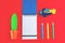 Colorful pencils, stationery, toy airplane on red