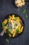 Colorful penne pasta with parmesan cheese and basil