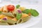 Colorful Penne Rigate noodles pasta meal with tomatoes