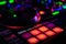 Colorful Performance MPC Pads on DJ Controller with blurred jog wheel