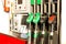 Colorful Petrol pump filling nozzles. Gas station in a service in daytime