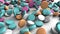 Colorful pharmaceutical pills fall down at pile on the white background. 3D animation closeup background